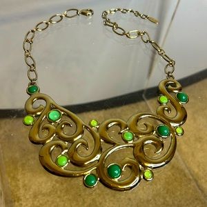 St. Thomas necklace with gold and green details.